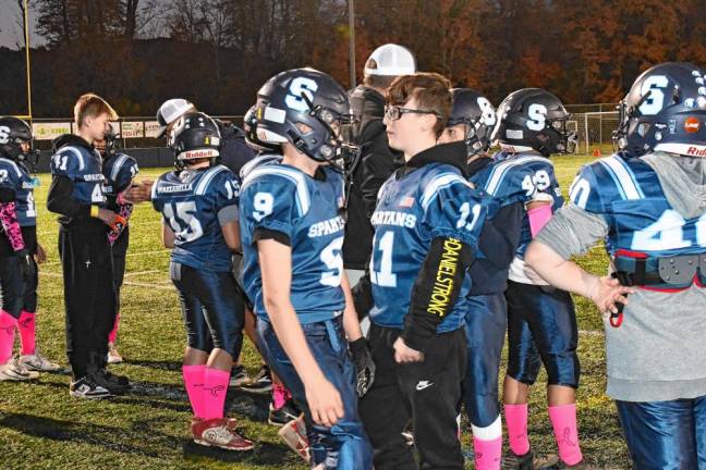 Daniel Bachkhaz (11) with his seventh-grade teammates Oct. 19. He led the team onto the field. (Photo by Maria Kovic)