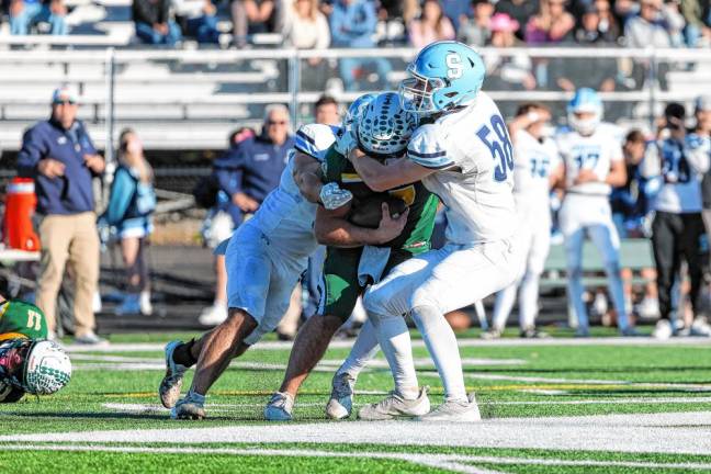 <b>Sparta linebacker Hunter Chlodnicki, left, and defensive end Austin McKenzie sack the Montville quarterback early in the fourth quarter. (Photo by Glenn Clark)</b>