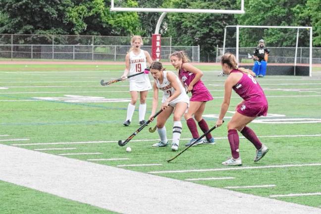 A Voorhees Viking controls the ball while shadowed by Newton Braves.