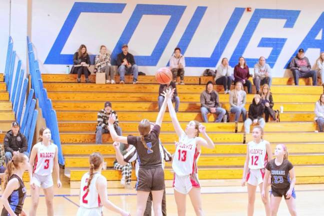 KT2 A Kittatinny Cougar and a High Point Wildcat reach for the ball during the tip-off to start the game.