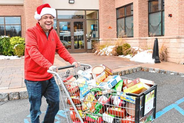 Steve Allan of radio station 102.3 WSUS brings donated food to a Sussex County Skylands Ride bus Friday, Nov. 22 at the Provident Bank in Sparta. (Photos by Maria Kovic)