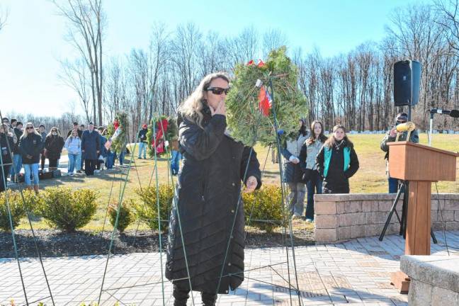 A woman places a wreath during the ceremony at the Northern New Jersey Veterans Memorial Cemetery in Sparta. (Photo by Maria Kovic)