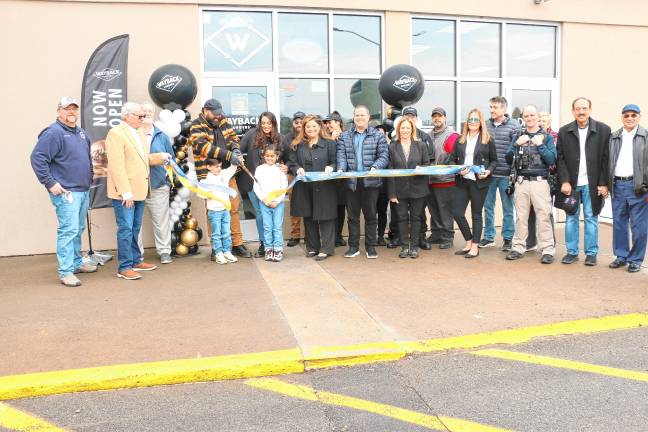 WB1 Wahab Abbasi cuts the ribbon at a ceremony to celebrate the opening of Wayback Burgers at 17 Hampton House Road, Newton, on Thursday, Feb. 27. (Photos by David Warner)