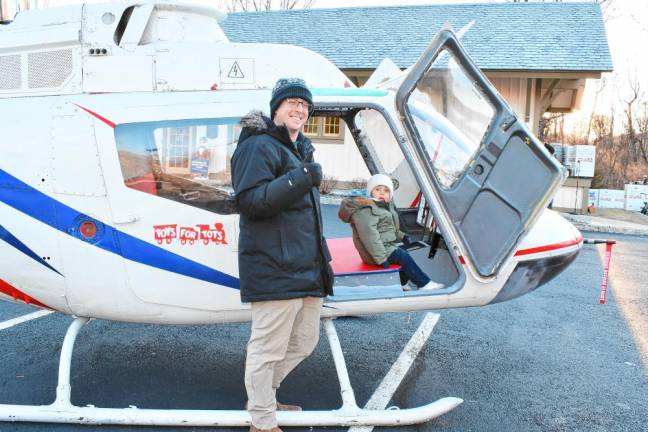 <b>Dan and Tom Nizolak of Sparta check out a Toys for Tots helicopter. (Photo by Maria Kovic)</b>