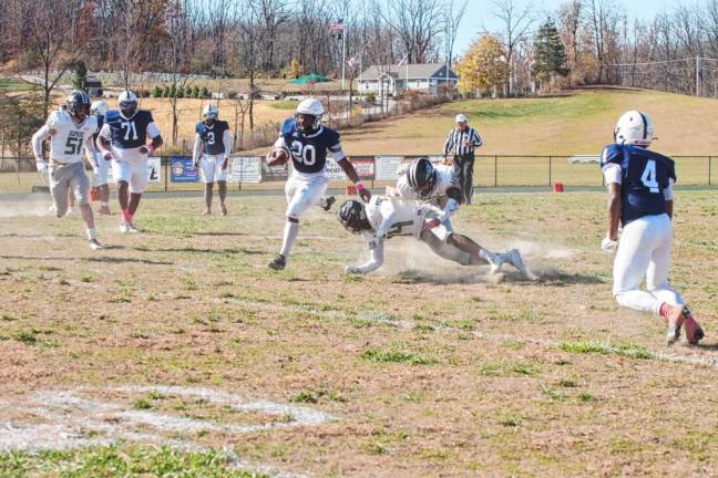 A Sussex County ball carrier avoids DuPage defenders.