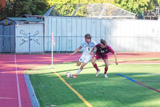 A Jefferson Falcon and a Newton Brave jostle each other while trying to get control of the ball.