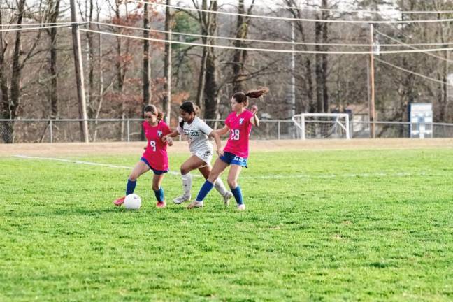 A Sussex Tech Mustang and Kittatinny Cougars battle for control of the soccer ball.