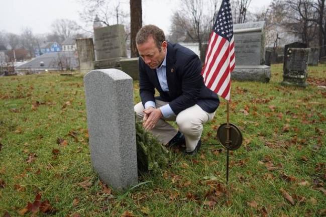 U.S. Rep. Gottheimer was instrumental in helping the Historical Society attain new markers for some of the graves at Old Newton Burial Ground. Pictured is Gottheimer as he pays honor tviews one of the tombstones that he helped the Historical Society attain.