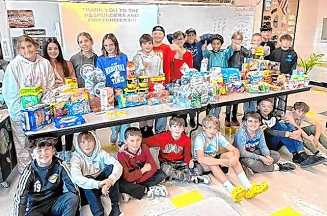 WF5 Sixth-grade students at Macopin Middle School in West Milford with items they collected for first-responders fighting the wildfires. (Photo provided)