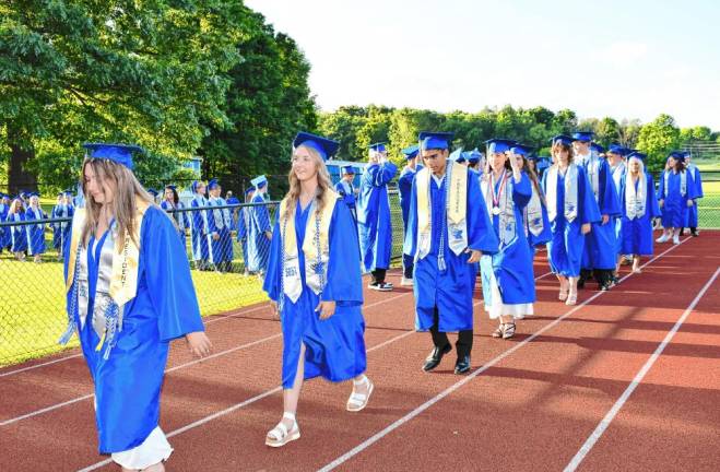 Members of the Class of 2024 march into the stadium for the commencement ceremony.