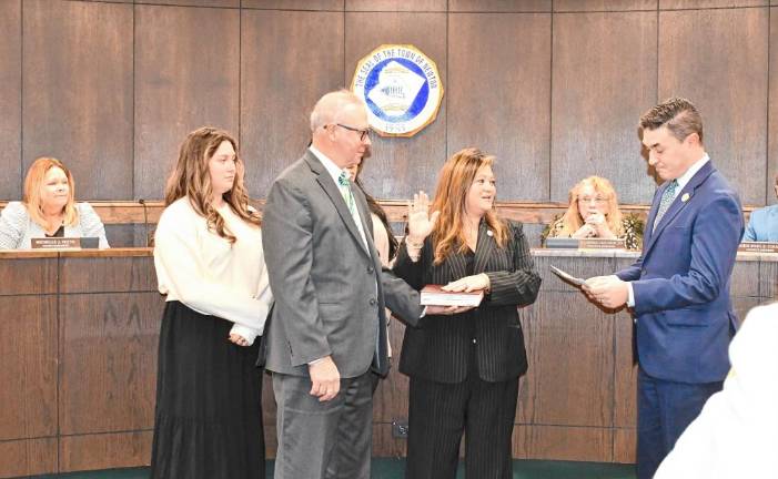 State Assemblyman Michael Inganamort administers the oath of office to Helen Le Frois, who will serve as mayor in 2025.