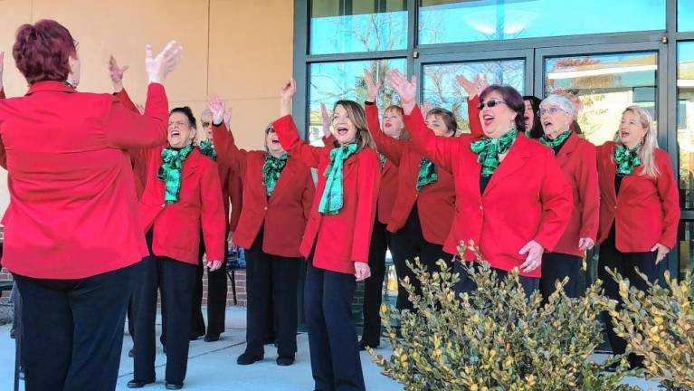 The a cappella group Harmony in Motion sings carols at the event.