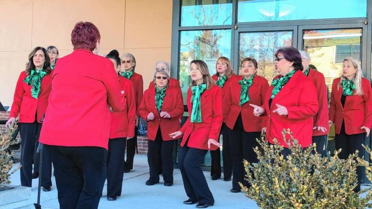 The a cappella group Harmony in Motion sings carols at the event.