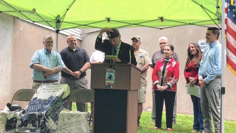 Bill Truran, Sussex County’s historian, puts on a miner’s hat worn by one of his family members.