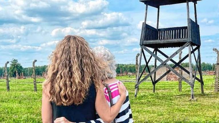 Mary Houghtaling visits the site of the Auschwitz-Birkenau concentration camp with Maude Dahme, a Holocaust survivor. (Photo provided)