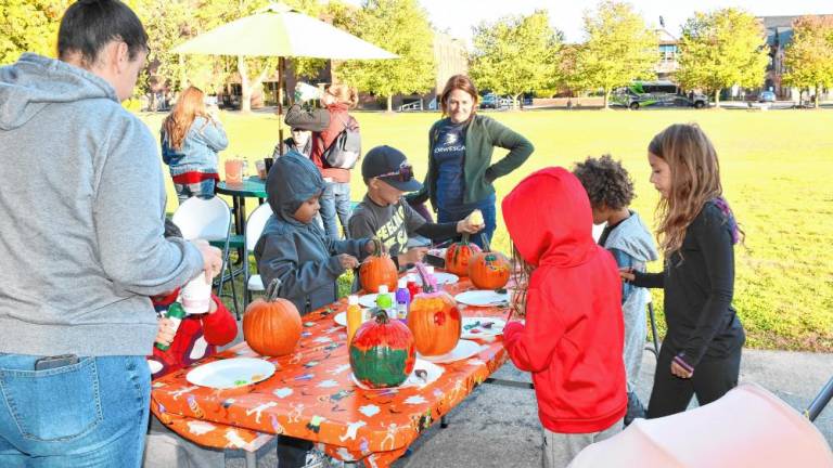 <b>Children paint pumpkins at Norwescap’s Fall Frolic in the Park on Thursday, Oct. 10 at Sussex County Community College in Newton. (Photos by Maria Kovic)</b>