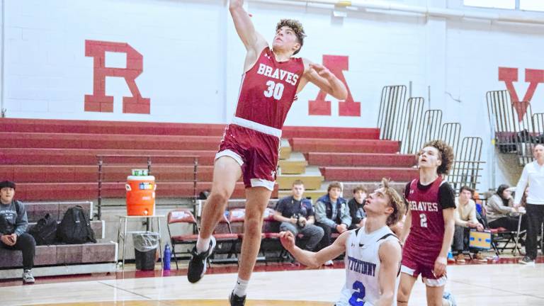 Newton's Maxwell Maslowski raises the ball during a shot in the game against Kittatinny on Tuesday, Feb. 11. The Braves won, 59-44, and Maslowski scored eight points. On Monday, Feb. 10, he scored the 1,000th point of his high school career in the game against Mount Olive. (Photos by George Leroy Hunter)