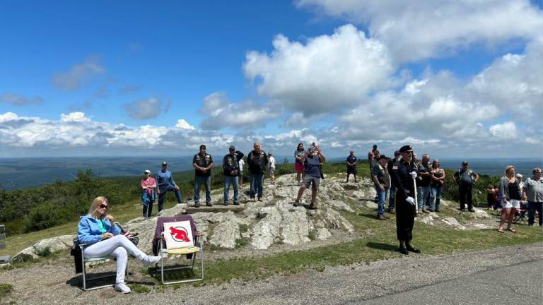 Veterans watch the memorial ceremony near the High Point Monument.