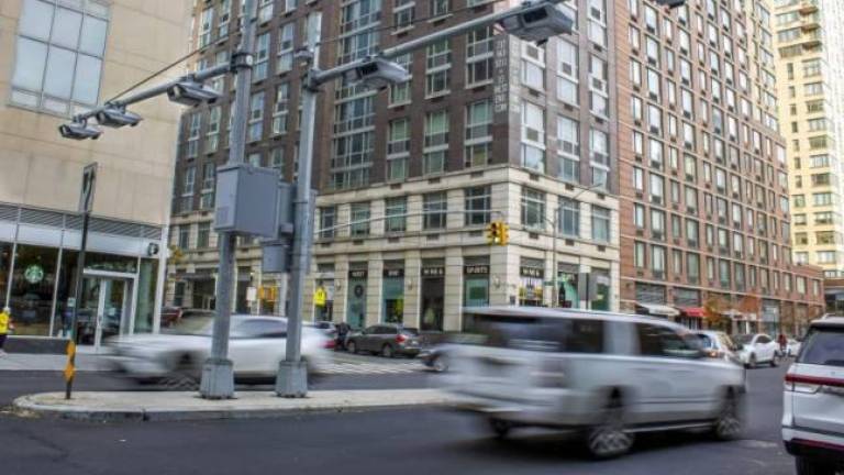 <b>Toll traffic cameras hang above West End Avenue near 61st Street in Manhattan. (File photo by Ted Shaffrey/AP)</b>